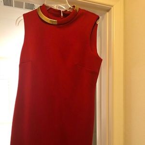 Red dress with gold band on the neck area